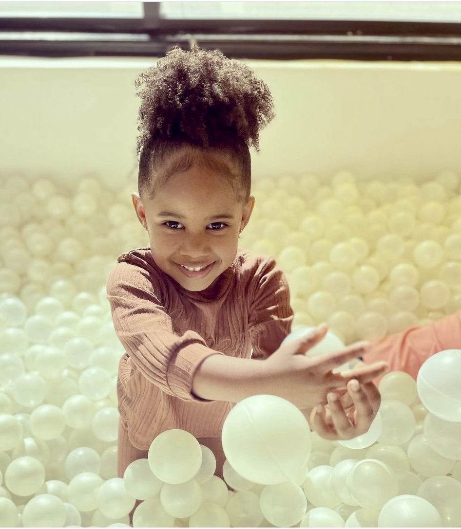 Little Girl playing in ball pit at Wild Child Kids Spa